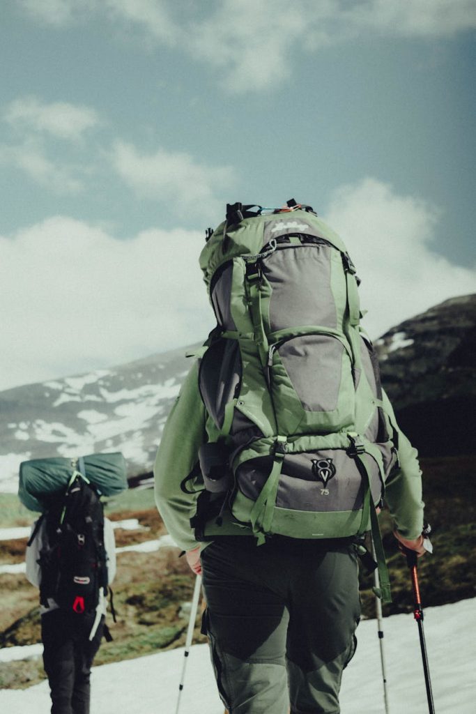 a man carrying a green backpack
