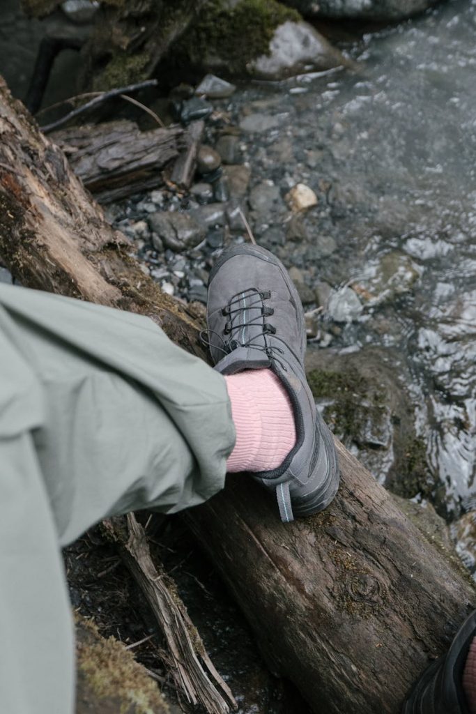walking shoes on damp log over stream UK countryside