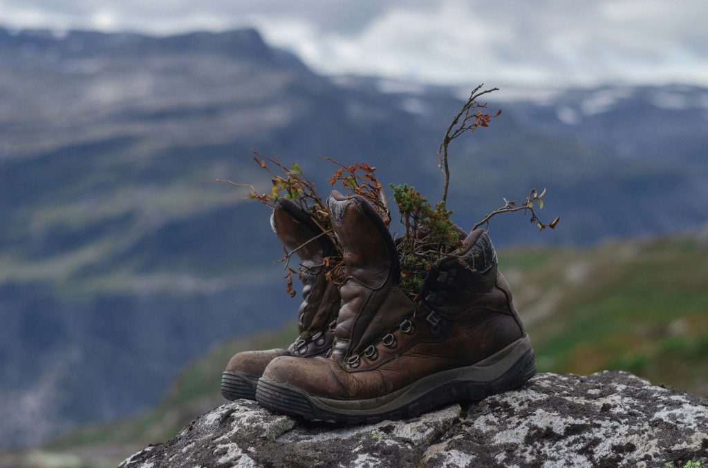 well worn hiking boots on a mountain viewpoint after a hike