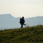 a person walking on a grassy field