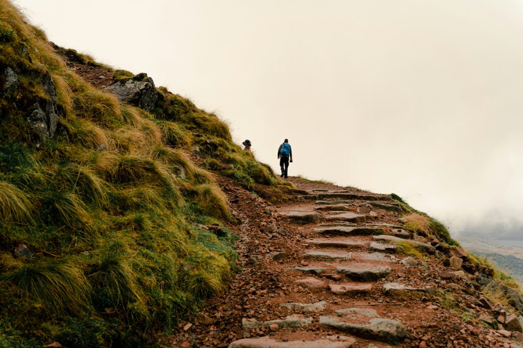 beginner hiker walking UK countryside path early morning