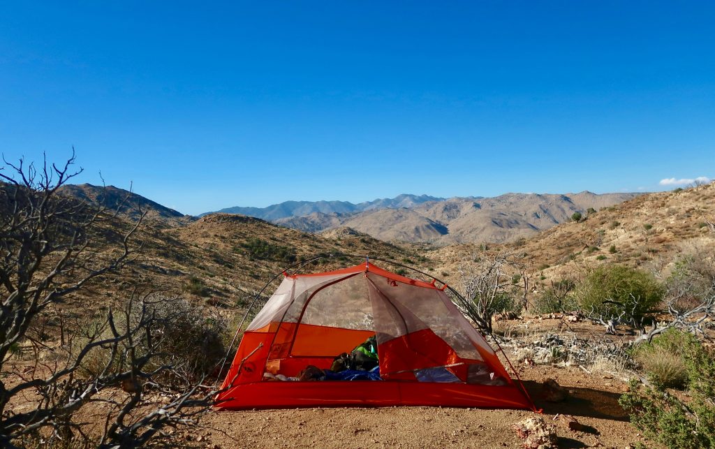 Ultralight 2 man tent pitched in a mountain landscape during a wild camping trip
