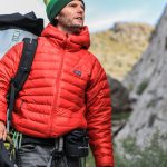 Man wearing a down jacket while hiking in the UK countryside