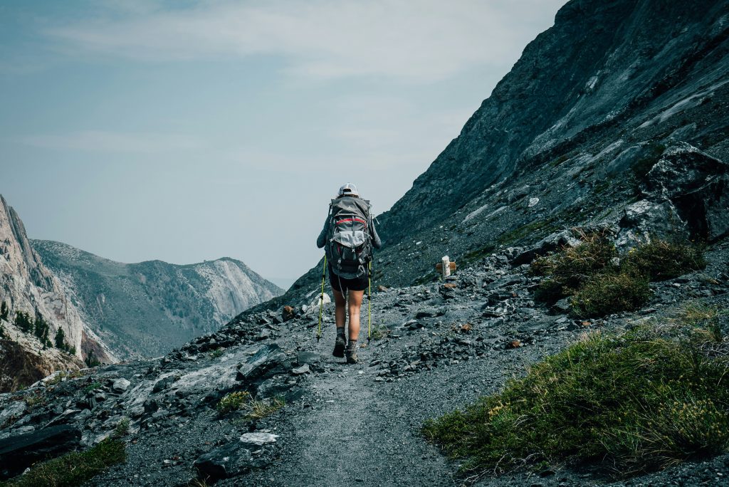Solo hiker walking on a mountain trail during a solo hike