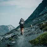 Solo hiker walking on a UK mountain trail