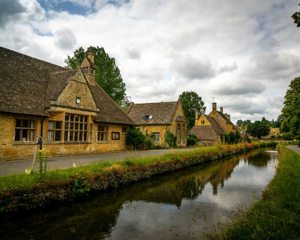 Cotswold village beside a river with old stone buildings